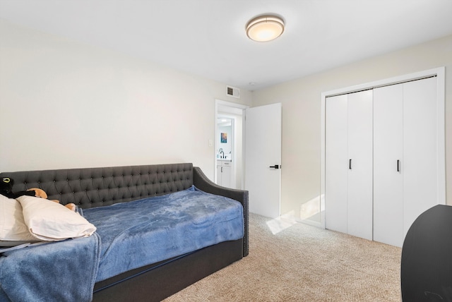 bedroom with a closet and light carpet