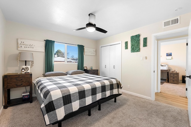 carpeted bedroom featuring ceiling fan and a closet