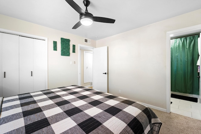 unfurnished bedroom with connected bathroom, carpet floors, visible vents, a ceiling fan, and a closet