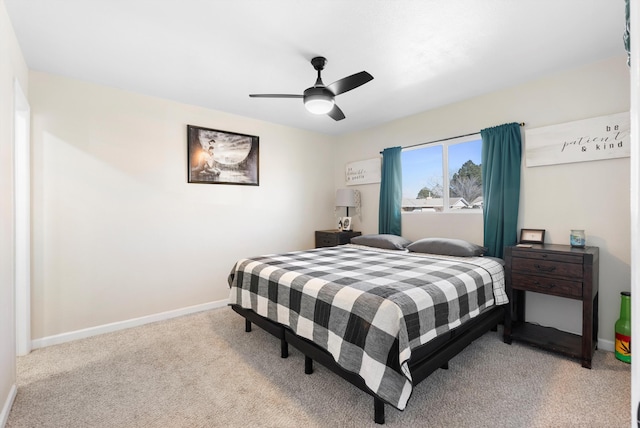 bedroom featuring a ceiling fan, light carpet, and baseboards