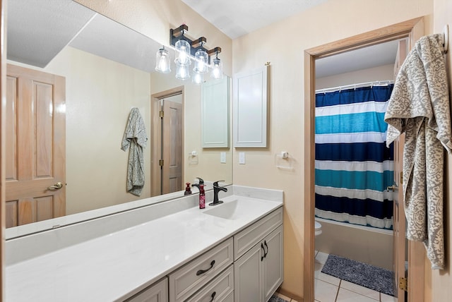 bathroom featuring vanity, tile patterned floors, and toilet