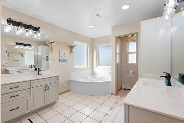 bathroom with a textured ceiling, a baseboard radiator, vanity, a bathing tub, and tile patterned flooring