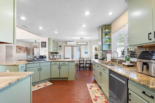 kitchen featuring a wall mounted air conditioner, dishwasher, sink, a center island, and green cabinetry