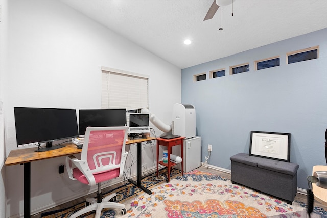 home office with hardwood / wood-style flooring, vaulted ceiling, a textured ceiling, and ceiling fan