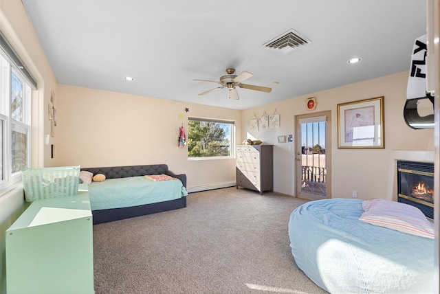 bedroom featuring ceiling fan, a baseboard heating unit, carpet flooring, and access to outside