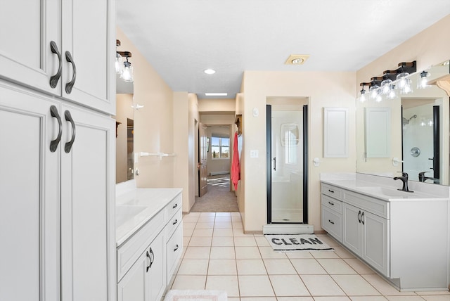 bathroom with vanity, tile patterned flooring, and walk in shower