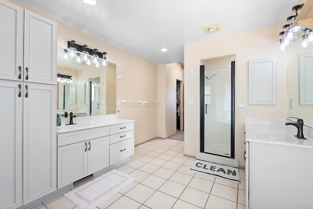 bathroom featuring tile patterned floors, vanity, and a shower with shower door