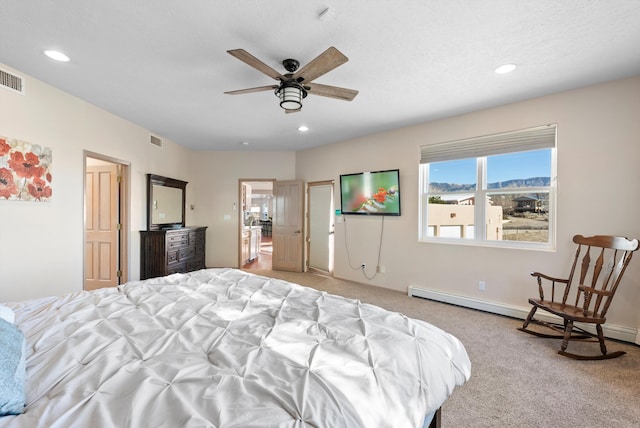 carpeted bedroom with a baseboard radiator and ceiling fan