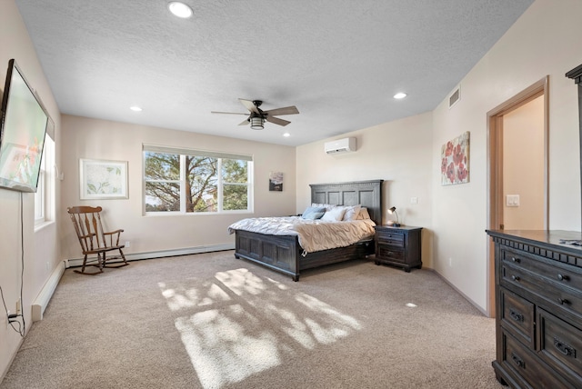 bedroom featuring a wall mounted air conditioner, light carpet, and a textured ceiling