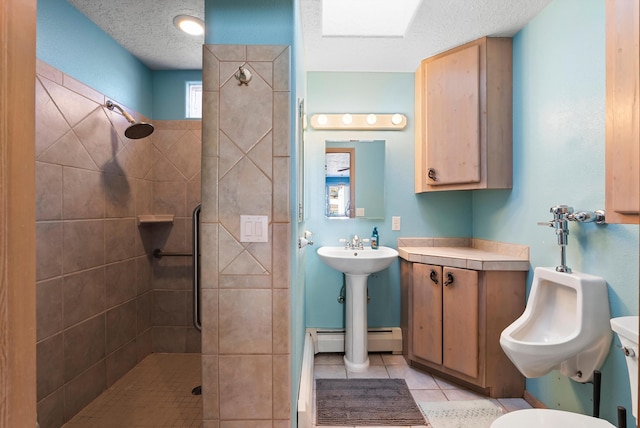 bathroom with baseboard heating, tiled shower, tile patterned flooring, and a textured ceiling