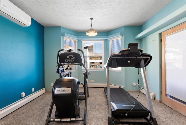 workout area featuring a baseboard heating unit, a textured ceiling, and a wall mounted AC