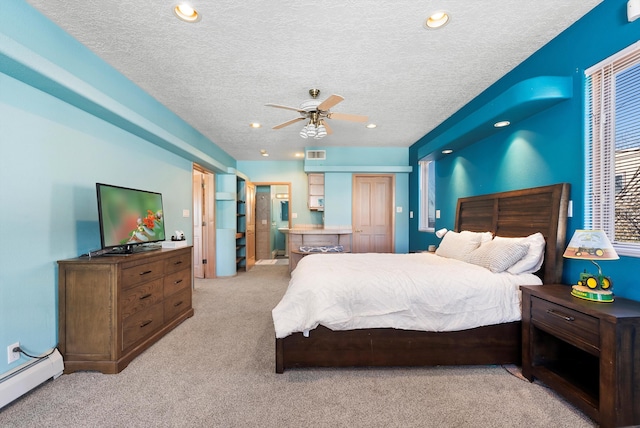 bedroom featuring a baseboard heating unit, light colored carpet, a textured ceiling, and ceiling fan