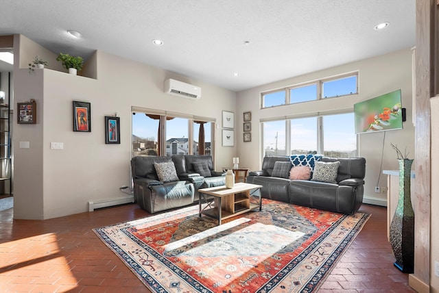 living room with a textured ceiling, a wall unit AC, and a baseboard heating unit