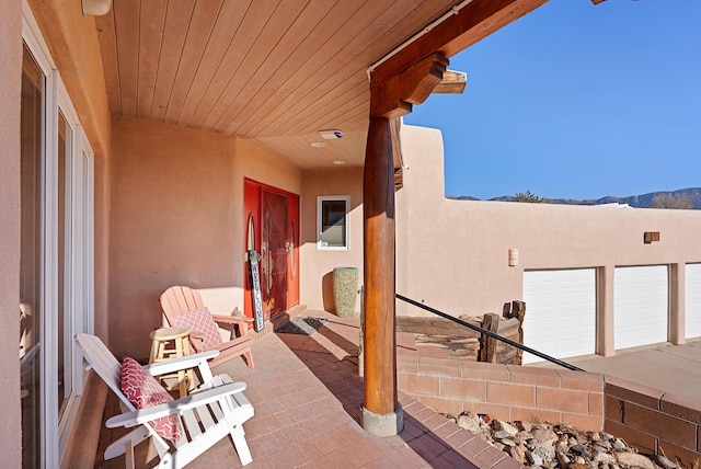 view of patio with a garage and a mountain view