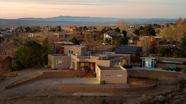 aerial view at dusk featuring a mountain view