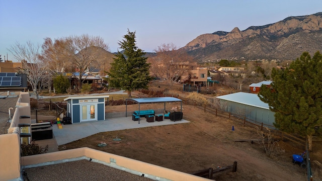 view of yard with a patio, a mountain view, an outbuilding, and central AC unit