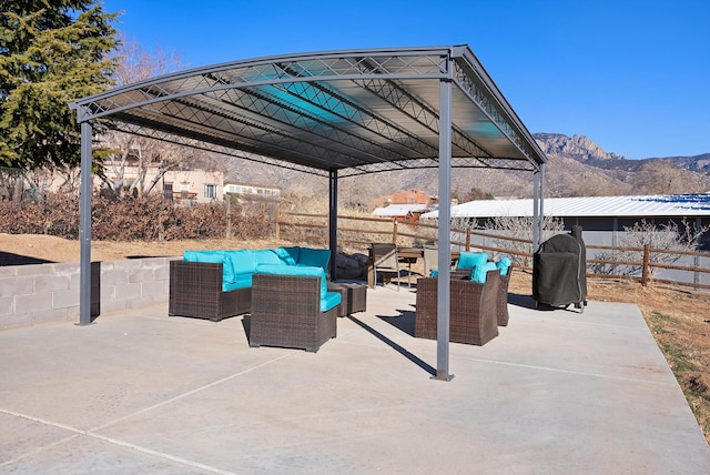 view of patio with a mountain view, outdoor lounge area, and a grill