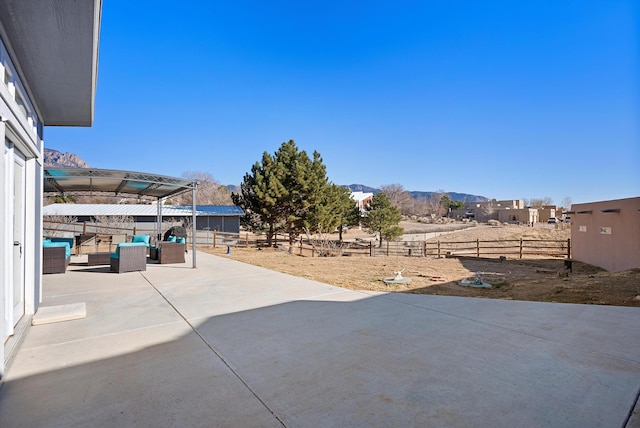 view of patio featuring an outdoor living space and a mountain view