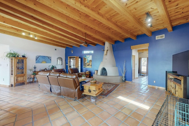 tiled living room featuring wooden ceiling and beam ceiling