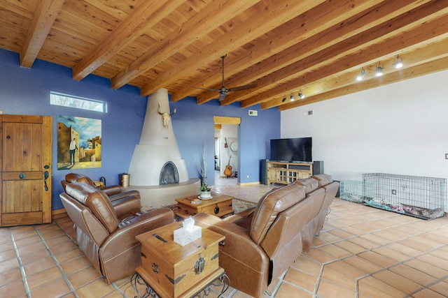 living room featuring light tile patterned flooring, rail lighting, wood ceiling, ceiling fan, and beam ceiling