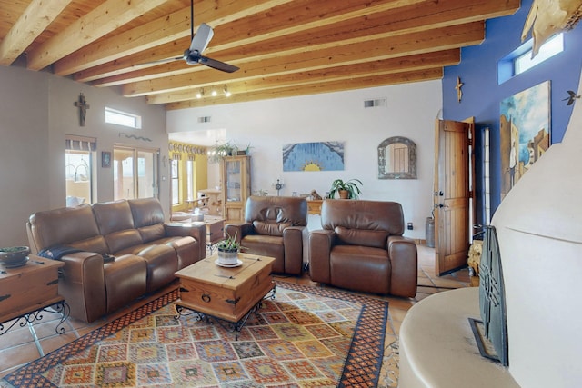 tiled living room featuring ceiling fan, a towering ceiling, and beam ceiling