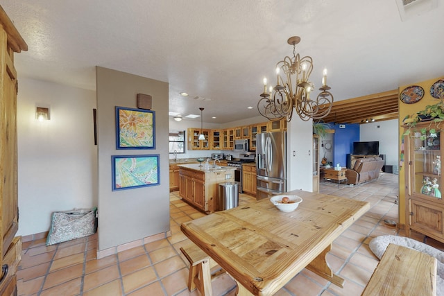 dining space with light tile patterned flooring and a chandelier