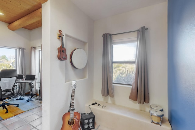 bathroom with light tile patterned floors, wood ceiling, and beam ceiling