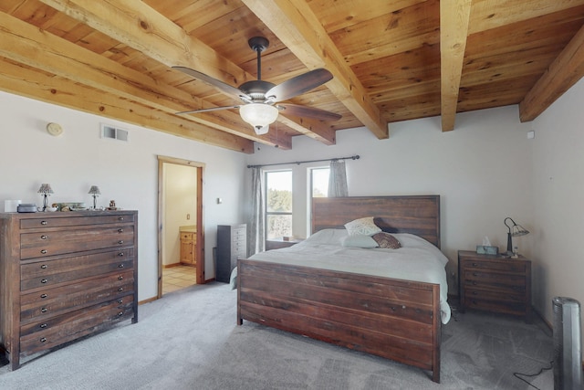 bedroom featuring beamed ceiling, light carpet, wood ceiling, and ensuite bath