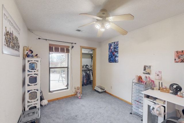 misc room featuring light carpet, a textured ceiling, and ceiling fan