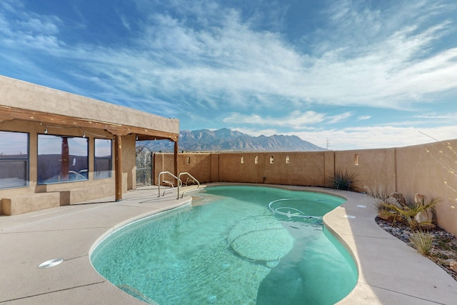 view of swimming pool with a mountain view