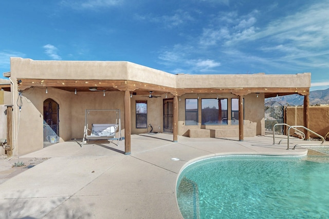 back of property featuring a patio area and ceiling fan