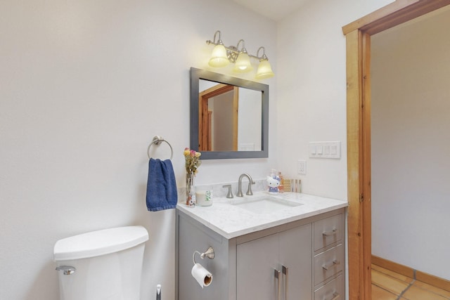 bathroom featuring vanity, tile patterned floors, and toilet