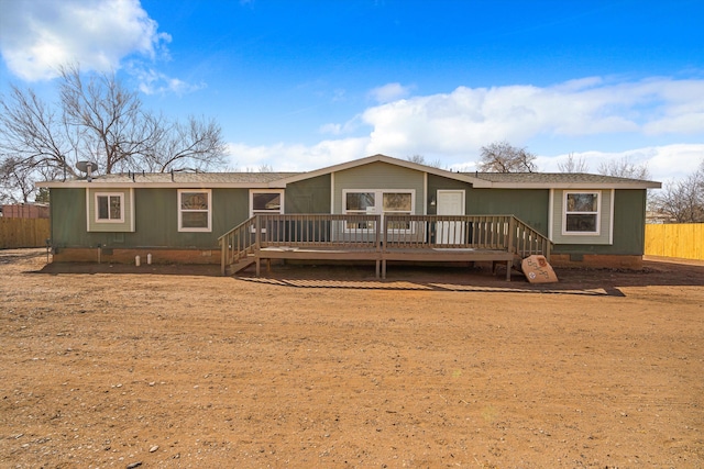 back of house with a deck