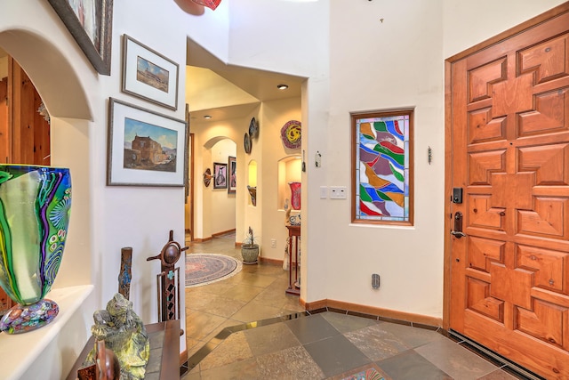 foyer entrance featuring a towering ceiling