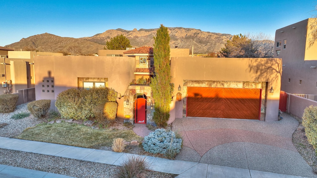 southwest-style home with a garage and a mountain view