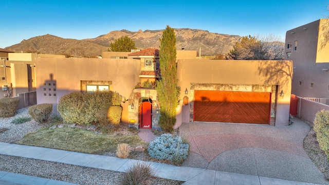 southwest-style home with a garage and a mountain view