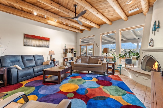 living room with plenty of natural light, wooden ceiling, beam ceiling, and light tile patterned floors