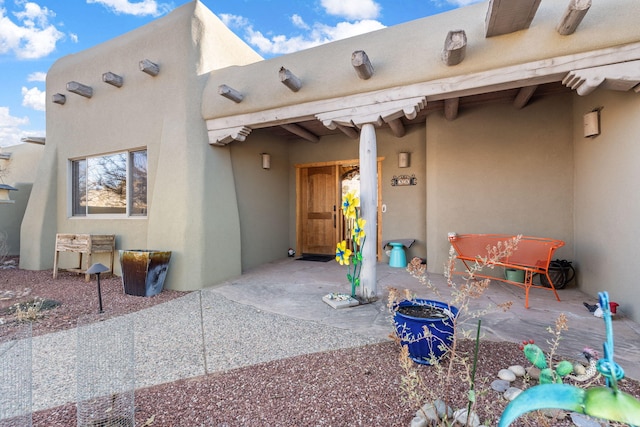 property entrance featuring a patio