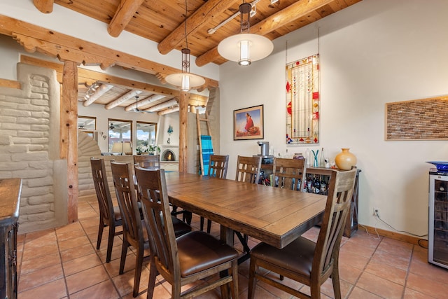 tiled dining area with wine cooler, wooden ceiling, and beamed ceiling