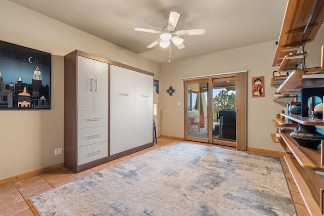 interior space featuring light tile patterned floors and ceiling fan