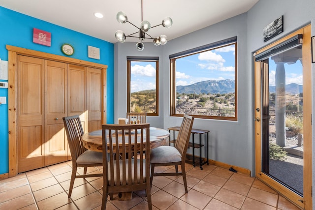 dining space featuring light tile patterned flooring, plenty of natural light, and a mountain view