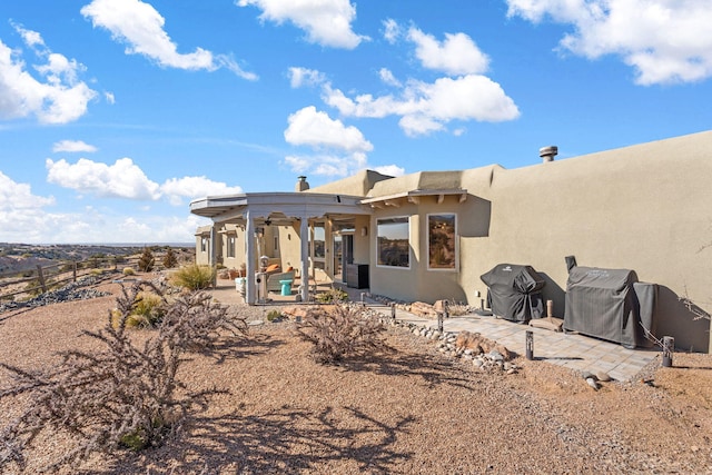 rear view of property featuring a patio area