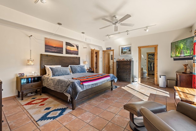 tiled bedroom with track lighting and ceiling fan