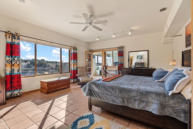 tiled bedroom featuring rail lighting and ceiling fan