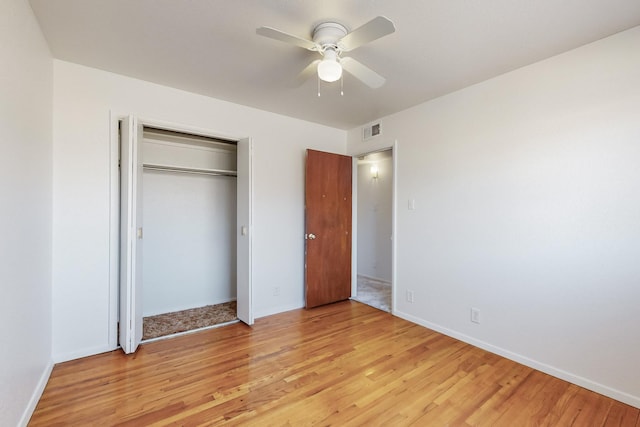 unfurnished bedroom with ceiling fan, light hardwood / wood-style floors, and a closet