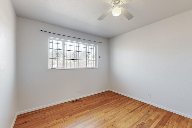 spare room with light hardwood / wood-style flooring and ceiling fan