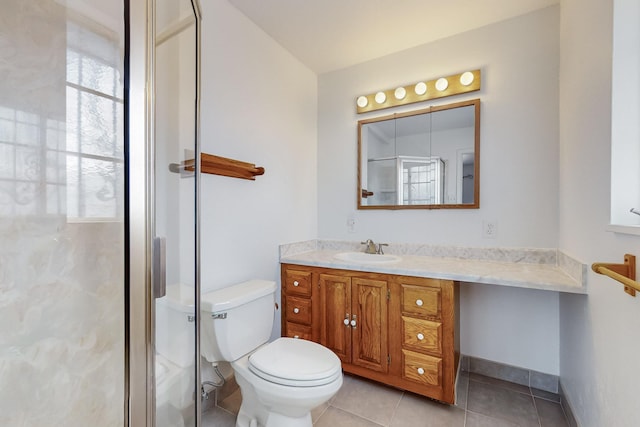 bathroom with vanity, walk in shower, tile patterned floors, and toilet