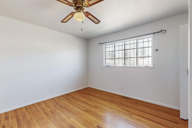 empty room with light hardwood / wood-style floors and ceiling fan