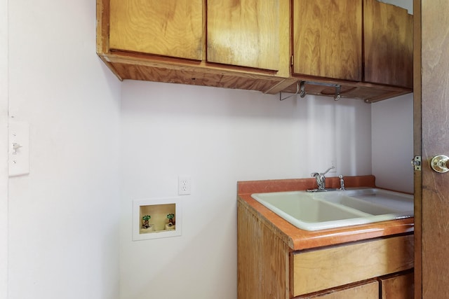 clothes washing area with cabinets, hookup for a washing machine, and sink