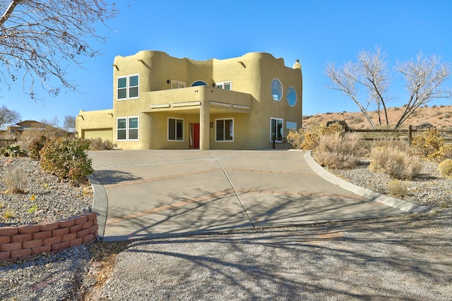 southwest-style home featuring a balcony